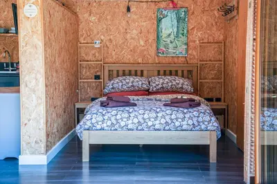 a bedroom with a bed in a room at The Chard, Netherby, a micro cabin in a rural setting with a hot tub in Longtown
