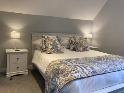 a bedroom with a bed and a night stand at Lord Galloway 37 with Hot Tub in Newton Stewart