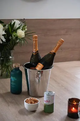 two bottles of champagne in a bucket on a table at Lord Galloway 38 with Hot Tub in Newton Stewart