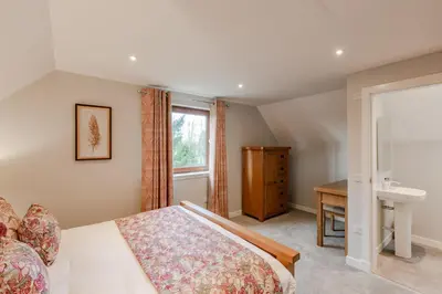 a bedroom with a bed and a sink at Lord Galloway 39 with Hot Tub in Newton Stewart