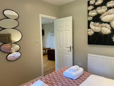 a bedroom with a bed with towels on it at Birch Lodge 17 with Hot Tub in Newton Stewart