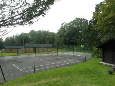 a tennis court with two tennis courts at Birch Lodge 17 with Hot Tub in Newton Stewart