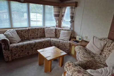 a living room with a couch and a coffee table at Caravan - Sleeps 4 - Pet friendly - Parking in Newton Stewart
