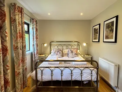 a bedroom with a metal bed in a room at Bluebell Lodge 5 with Hot Tub in Newton Stewart