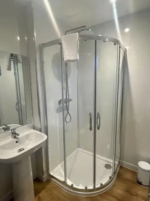 a bathroom with a shower and a sink at Bluebell Lodge 5 with Hot Tub in Newton Stewart