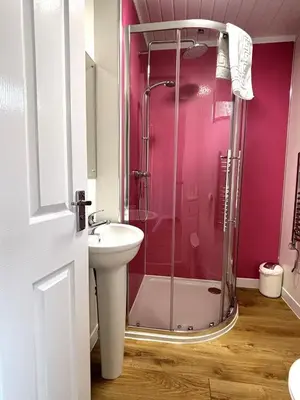 a bathroom with a shower and a sink at Bluebell Lodge 9 with Hot Tub in Newton Stewart