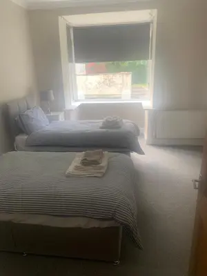 two beds in a bedroom with a window at Elegant bungalow in Newmilns, East Ayrshire in Newmilns