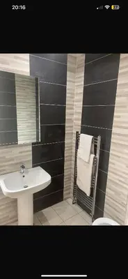 a bathroom with a sink and a towel rack at Elegant bungalow in Newmilns, East Ayrshire in Newmilns