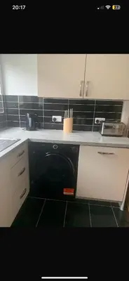 a kitchen with a dishwasher in the middle of a kitchen at Elegant bungalow in Newmilns, East Ayrshire in Newmilns