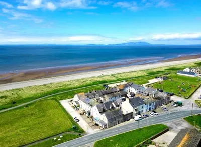 an aerial view of a house next to the ocean at Sunset House On The Beach in Maryport