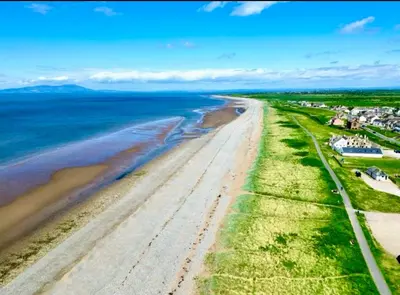 an aerial view of a beach with houses and the ocean at Sunset House On The Beach in Maryport