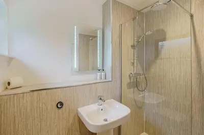 a bathroom with a sink and a shower at Birch Lodge 21 with Hot Tub in Newton Stewart