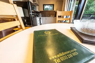 a book sitting on top of a table at Birch Lodge 22 with Hot Tub in Newton Stewart