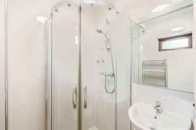 a bathroom with a shower and a sink at Conifer Lodge 25 with Hot Tub in Newton Stewart