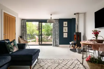 a living room with a couch and a table at Daisy Cottage, Dalston, peaceful, rural setting with garden & hot tub in Carlisle