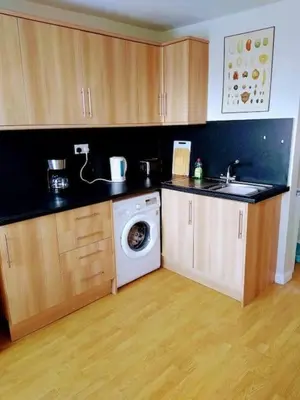 a kitchen with a washing machine and a sink at 2 Bed pet-free cottage, private garden & fell view in Arlecdon
