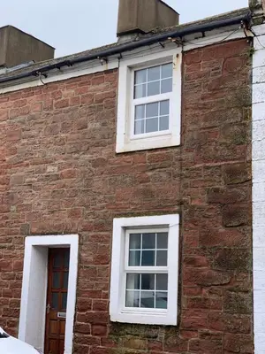 a brick building with three windows on it at 18 Main Street in St Bees