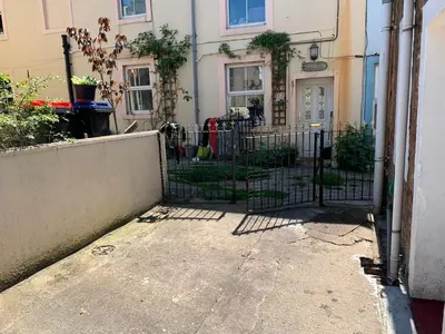 a gate in front of a house with a fence at 18 Main Street in St Bees