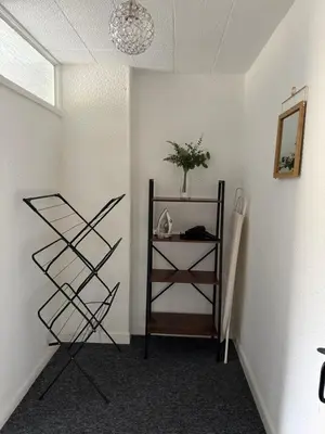 a room with a shelf and a mirror on a wall at 18 Main Street in St Bees