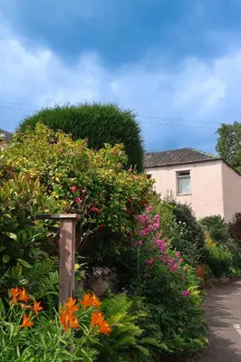 a garden of flowers in front of a house at 5 Greta Side Court in Keswick