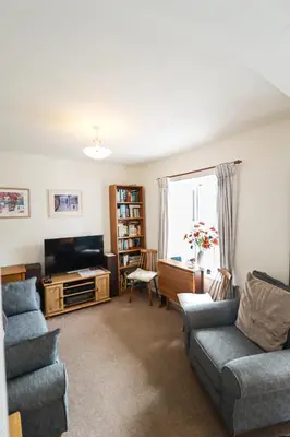 a living room with a couch and a tv at 5 Greta Side Court in Keswick
