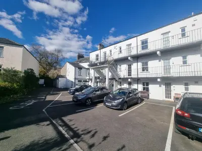 two cars parked in a parking lot in front of a building at 5 Greta Side Court in Keswick