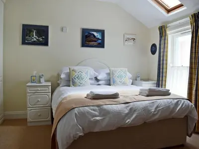 a bedroom with a bed with two towels on it at 9 Greta Grove House in Keswick