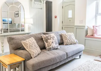a living room with a couch and a table at Brandelhowe in Keswick