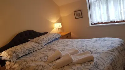 a bedroom with a bed with towels on it at Catbells in Keswick