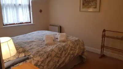 a bedroom with a bed with two towels on it at Catbells in Keswick