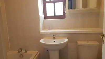 a bathroom with a sink and a toilet and a window at Catbells in Keswick