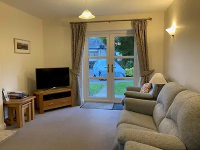 a living room with a couch and a television at Latrigg View in Keswick