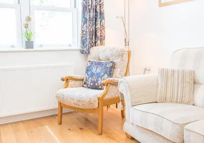 a living room with a chair and a couch at Riverside View in Keswick