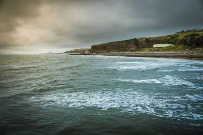 a view of a body of water with a beach at HAVEN STUDIO GROUND FLOOR in Whitehaven