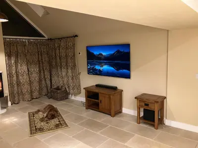a living room with a tv on the wall at Cherry Tree Cottage in Stranraer