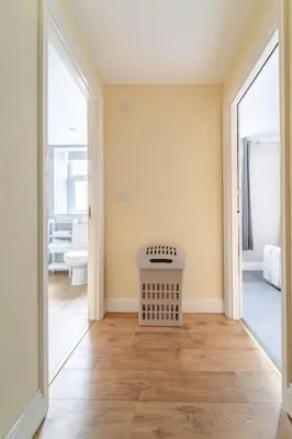 an empty room with a hallway with a table at The Blue House holiday home in Egremont