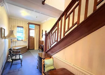 a hallway with a staircase in a home with a desk at Beautiful Period Property in Central Location - Pass the Keys in Maxwelltown
