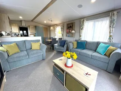a living room with two blue couches and a table at Beautiful 2BR In Kippford With Incredible Views - Pass the Keys in Palnackie