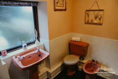 a bathroom with a toilet and a sink at Pine lodge by Prestige Properties SA in Seascale