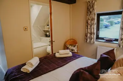 a bedroom with a bed with towels on it at Pine lodge by Prestige Properties SA in Seascale