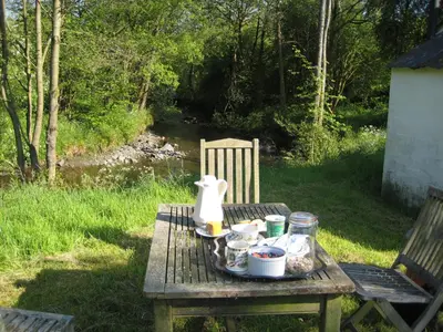 a picnic table with food and a tea kettle on it at Riverside House in Thornhill