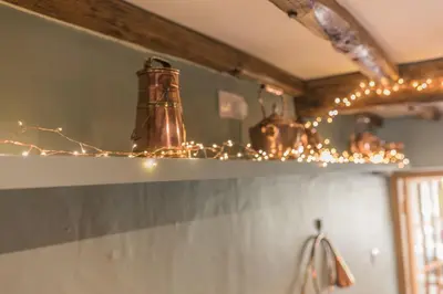 a chandelier with lights on top of a shelf at Slater Bob's Coppermines Valley in Coniston