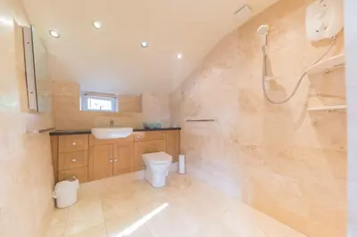 a bathroom with a toilet and a sink and a shower at Slater Bob's Coppermines Valley in Coniston