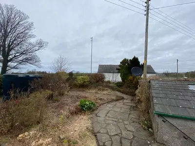 a stone path in a yard with a house at lake District cottage in Bootle