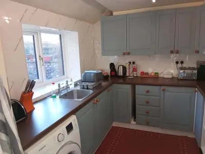 a small kitchen with a sink and a microwave at lake District cottage in Bootle