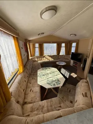 a living room with a couch and a table at JS Holidays The Westmorland Lagganhouse in Ballantrae