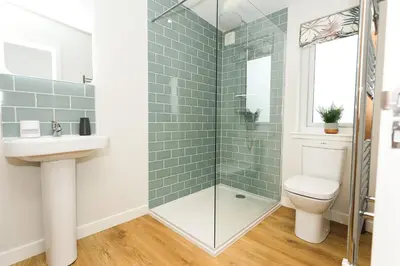 a bathroom with a shower and a toilet and a sink at Ocean Drive in Gatehouse of Fleet