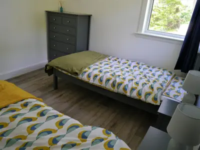 a bedroom with a bed and a dresser at Mallaig in Rockcliffe