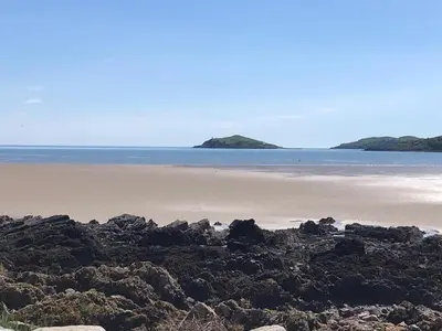 a beach with lots of rocks and the ocean at Mallaig in Rockcliffe