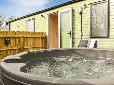 a large hot tub in front of a house at Beech Tree in Westward